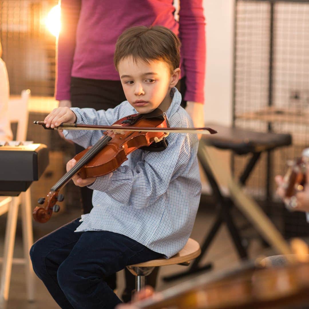 A young boy playing the violin.