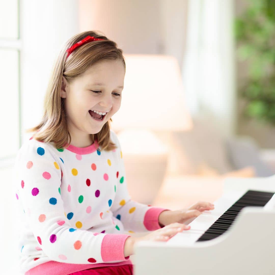 A young girl playing the piano.