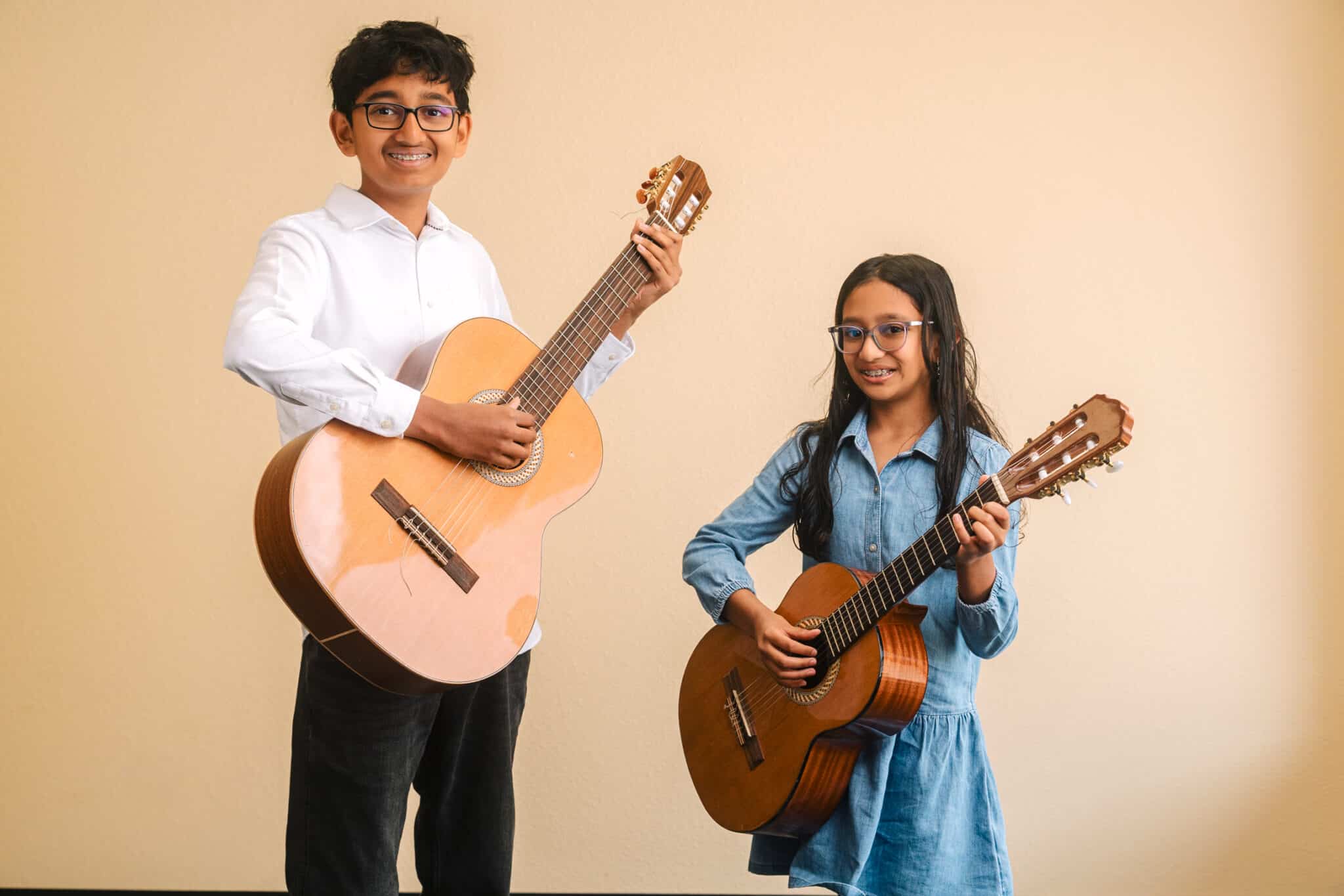Two CCM students playing guitar