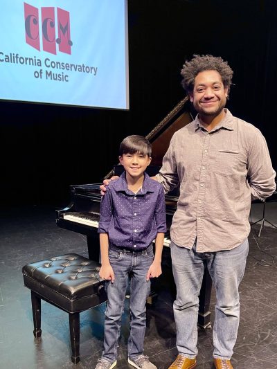 student of the month, elijah, with teacher dario